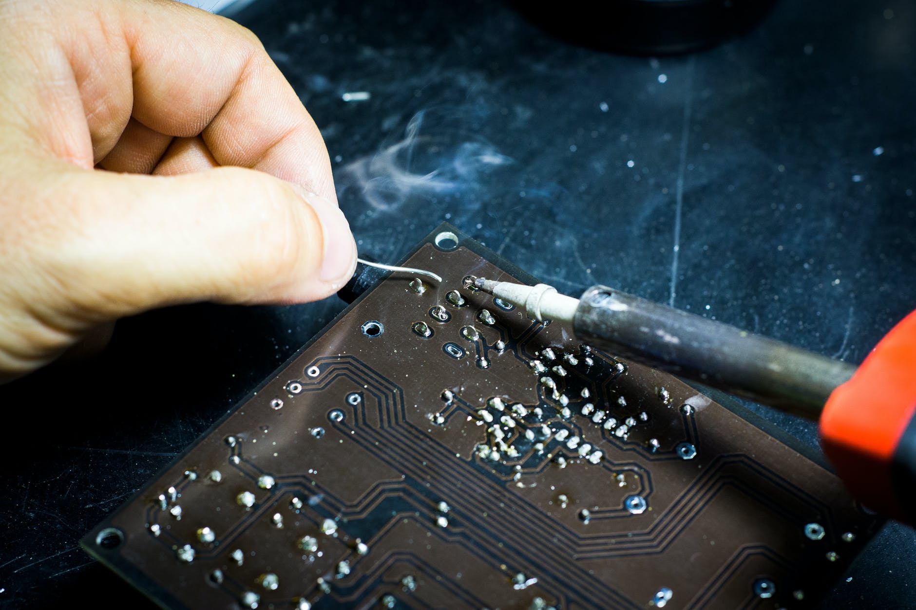 person soldering chip